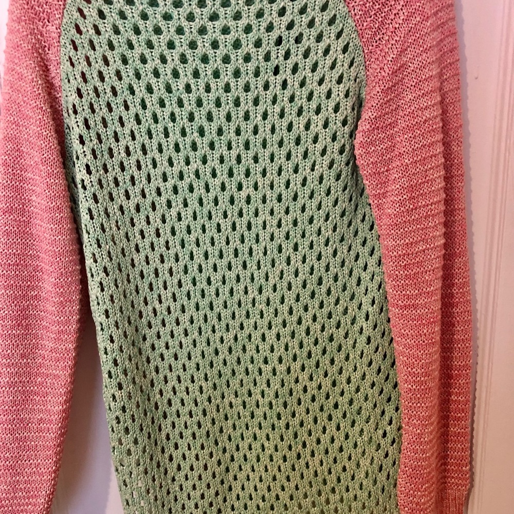 Pink, green and brown sweater with cutout detail in back